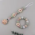 Detail of food-grade silicone daisy pacifier clip and wooden teething bracelet set - Beige
