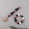 Detail of daisy silicone pacifier clip and matching baby teething bracelet set - Black