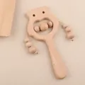 Detail of owl wooden baby rattle with smooth beechwood texture and movable beads - Owl