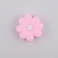 Macro detail of pink daisy silicone straw topper bead with a white octagonal center hole - Pink & White