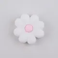 Close-up of a white and pink silicone daisy flower bead for DIY jewelry and crafts - White Pink