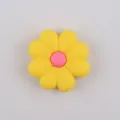 Macro shot of yellow silicone daisy flower bead with pink center for DIY jewelry and shoes - Yellow Red