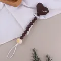 Detailed view of silicone pacifier clip with heart shape and Lucky embroidery - Coffee