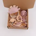 Pink silicone and wood baby teether set with dinosaur ring and pacifier clip in a gift box - Dusty Rose
