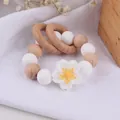 Beech wood and white silicone flower baby teether bracelet with rattle rings - Yellow