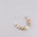 Silicone daisy teething necklace with white and green beads and natural wood accents - Yellow Daisy Style