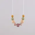Silicone teething necklace with sage green and floral beads on white string - Dusty Rose