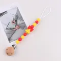 Red and yellow silicone bead pacifier clip with a wooden clasp and a cute bell charm - Christmas Bell
