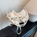 Creamy white bow shoulder bag with decorative pearl and floral silver chain strap - White