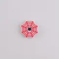 Silicone bead for DIY crafts featuring a red and white spiderweb with a black spider charm - Red