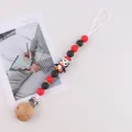 Silicone pacifier clip with red and black beads and a cute Christmas penguin character - Christmas Penguin