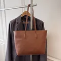 Minimalist large brown leather tote bag with long straps for versatile daily commuting - Brown