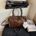 Brown Boston handbag in lychee texture with FASHION AIR PARIS text and plush charm - No Pendant / Brown