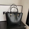 Klassieke zwarte lederen tote bag met lange schouderbanden en gouden hardware - Zwart