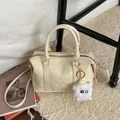 Cream white Boston handbag with textured leather finish and plush doll charm - No Pendant / White