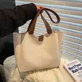 Cream tote bag with brown handles and decorative vertical stitching detail - Off White