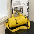Lightweight bright yellow cylinder canvas travel bag with adjustable shoulder strap - Yellow