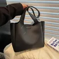 Minimalist black tote bag in matte faux leather with vertical stitching and long strap - Black
