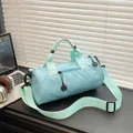 Light blue canvas barrel bag with adjustable strap and handles for travel and fitness - Blue