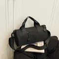 Minimalist black canvas duffel bag for fitness and travel with adjustable shoulder strap - Black