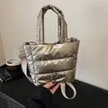 Quilted padded handbag in metallic gold with adjustable strap and top handle design - Gold