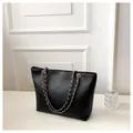 Large black snake-embossed tote bag with elegant gold chain straps for daily commute - Black