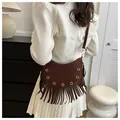 Dark brown suede crescent bag with metal grommets and long fringe tassels - Brown