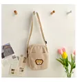 Beige corduroy crossbody bag for kids featuring a cute plush bear patch and strap - Khaki