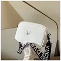 Detail of white nylon square bag with silver butterfly buckle and wide lettered strap - White