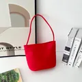 Detail of red nylon bucket bag featuring Love and Fearless embroidery with handle - S / Red