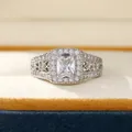 Macro view of square cushion-cut zircon ring with intricate filigree and pave details - US 6 / Silver Plated