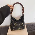 Elegant black satin tote bag with golden butterfly embroidery and beaded wood handles - Black