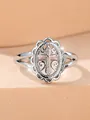 Close-up of vintage hollow lace ring with rose gold cross and scroll patterns - US 6