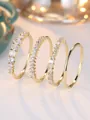 Detail of four-piece gold rings set featuring sparkling clear cubic zirconia stones - US 5 / Gold (White Zirconia)