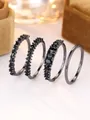 Detailed view of 4-piece set featuring black cubic zirconia rings and a sleek minimalist band - US 5 / Black Gold (Black Cubic Zirconia)