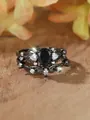 Macro detail of black vintage leaf rings with pear-cut blue sandstone and white zircon stones - 6 / Black Gold