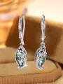Macro shot of silver leverback earrings with moss agate drop in filigree leaf design - Silver and Green