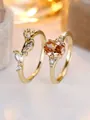 Macro detail of oval orange gemstone ring set with marquise zircon vine band - US 6 / Champagne Gold