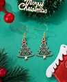Detailed view of green Christmas tree drop earrings with red accents on festive background - Christmas Tree with Red Star
