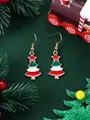 Detailed view of festive Christmas tree dangle earrings with colorful enamel on green background - Enamel Christmas Tree