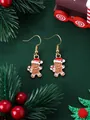 Macro detail of gingerbread man Christmas earrings with festive gold hooks and enamel finish - Gingerbread Man