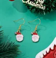 Detail of Christmas Santa Claus drop earrings with festive gold plating and enamel finish - Santa with Red Hat and Gem