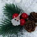 Macro detail of silver Santa Claus and hat pendant with zircon inlay on a festive background - Silver Full Zircon Santa