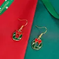 Christmas holly wreath earrings with red bows and gold hooks on festive fabric - Holly Wreath