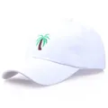 White cotton baseball cap featuring green palm tree embroidery on front panel - Adjustable / White