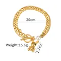 Detail view of gold bear pendant and pearl on double-layer stainless steel bracelet - Pearl Bear OT Clasp Style (B1026)