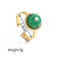 Detail of adjustable 18K gold ring with green gemstone showing 1.8cm diameter and 3g weight - Round Green Stone Ring