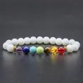 Detailed close-up of chakra yoga bracelet with white beads and colorful stones - Porcelain White Colorful Chakra Bracelet