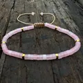 Adjustable natural pink stone beaded bracelet with gold accents on dark wooden background - Rose Quartz With Gold Spacers