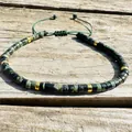 Close-up of adjustable marble natural stone bead bracelet with gold metal spacers - African Pine With Gold Spacers